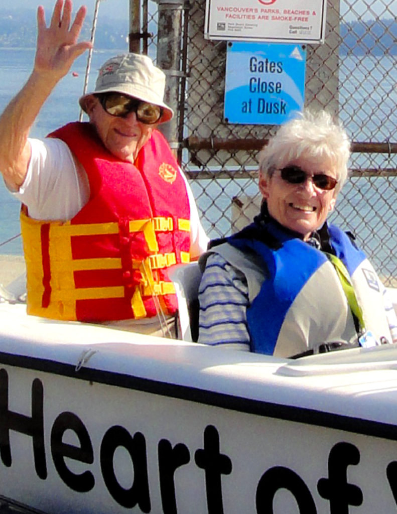 Jack Tait and Jean Donaldson posing in sailboat.