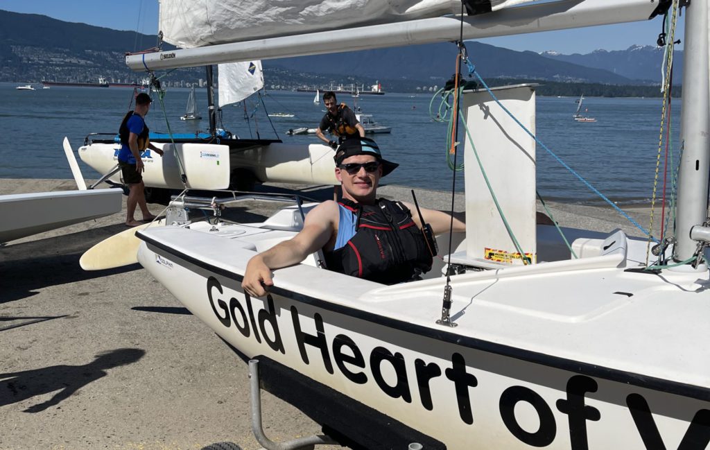 Joshua in a Martin 16 adapted sailboat getting ready to sail at the Jericho Sailing Centre.