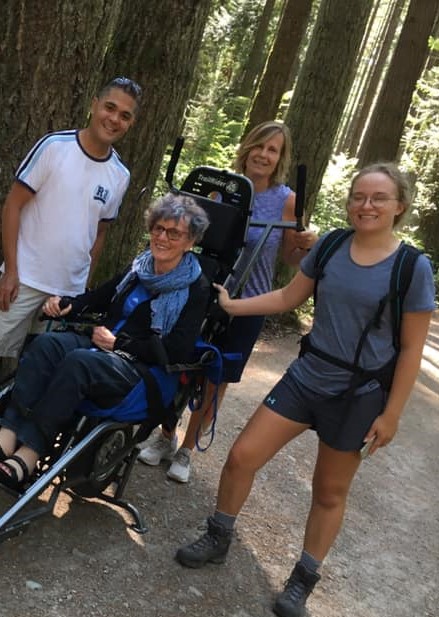 Maria and volunteers on a hike with a TrailRider.