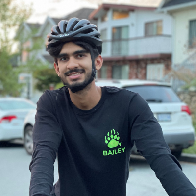 Sahil wearing a bike helmet smiling