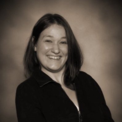 Carrie Torrans smiling at camera in black and white